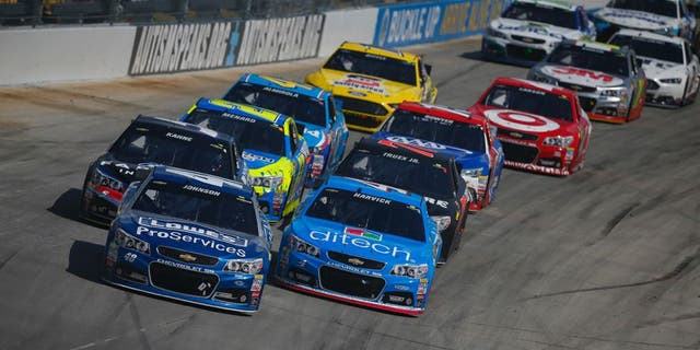 Jimmie Johnson, driver of the #48 Lowe's Pro Services Chevrolet, leads a pack of cars during the NASCAR Sprint Cup Series FedEx 400 Benefiting Autism Speaks at Dover International Speedway on May 31, 2015 in Dover, Delaware.