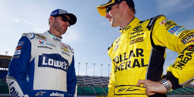 KANSAS CITY, KS - MAY 06: Matt Kenseth, driver of the #20 Dollar General Toyota, speaks with Jimmie Johnson, driver of the #48 Lowe's Chevrolet, during qualifying for the NASCAR Sprint Cup Series Go Bowling 400 at Kansas Speedway on May 6, 2016 in Kansas City, Kansas. (Photo by Jamie Squire/Getty Images)