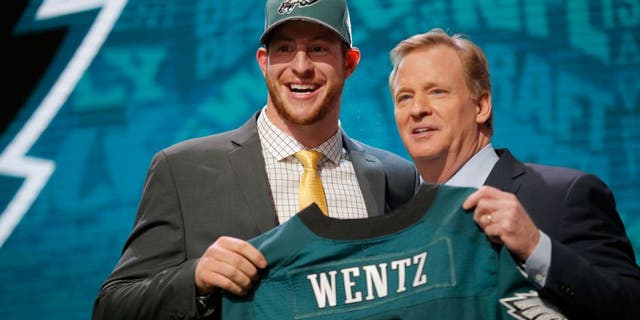 CHICAGO, IL - APRIL 28: (L-R) Carson Wentz of the North Dakota State Bison holds up a jersey with NFL Commissioner Roger Goodell after being picked #2 overall by the Philadelphia Eagles during the first round of the 2016 NFL Draft at the Auditorium Theatre of Roosevelt University on April 28, 2016 in Chicago, Illinois. (Photo by Jon Durr/Getty Images)