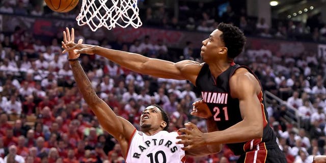 May 3, 2016; Toronto, Ontario, CAN; Toronto Raptors guard DeMar DeRozan (10) has a shot blocked by Miami Heat center Hassan Whiteside (21) in game one of the second round of the NBA Playoffs at Air Canada Centre. The Heat won 102-96. Mandatory Credit: Dan Hamilton-USA TODAY Sports