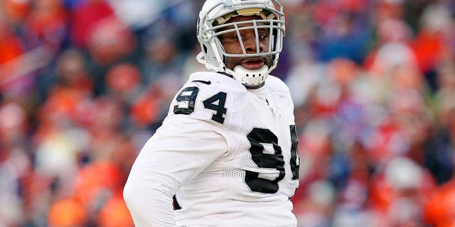 Dec 28, 2014; Denver, CO, USA; Oakland Raiders defensive tackle Antonio Smith (94) in the first quarter against the Denver Broncos at Sports Authority Field at Mile High. The Broncos defeated the Raiders 47-14. Mandatory Credit: Isaiah J. Downing-USA TODAY Sports