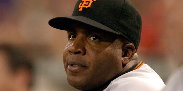 Barry Bonds #25 of the San Francisco Giants watches the game against the Washington Nationals from the dugout at RFK Stadium August 31, 2007 in Washington, DC.