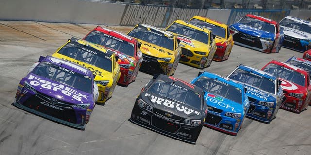 Denny Hamlin, driver of the #11 FedEx Cares Toyota, leads a pack of cars during the NASCAR Sprint Cup Series FedEx 400 Benefiting Autism Speaks at Dover International Speedway on May 31, 2015 in Dover, Delaware.