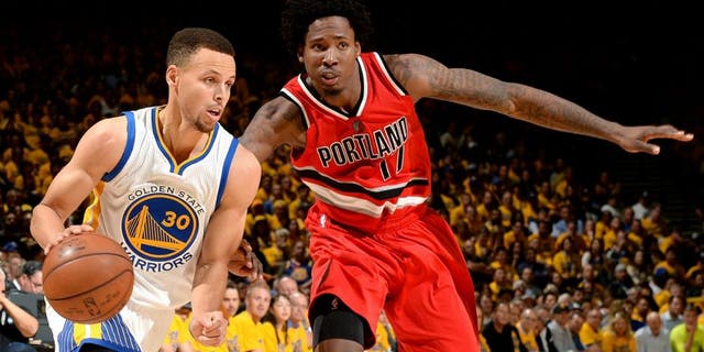 OAKLAND, CA - MAY 11: Stephen Curry #30 of the Golden State Warriors drives to the basket during the game against Ed Davis #17 of the Portland Trail Blazers in Game Five of the Western Conference Semifinals during the 2016 NBA Playoffs on May 11, 2016 at ORACLE Arena in Oakland, California. NOTE TO USER: User expressly acknowledges and agrees that, by downloading and or using this photograph, user is consenting to the terms and conditions of Getty Images License Agreement. Mandatory Copyright Notice: Copyright 2016 NBAE (Photo by Garrett Ellwood/NBAE via Getty Images)