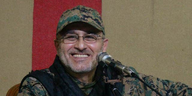 This undated handout image released on Friday, May 13, 2016, by Hezbollah Media Department, shows slain top military commander Mustafa Badreddine smiling during a meeting.