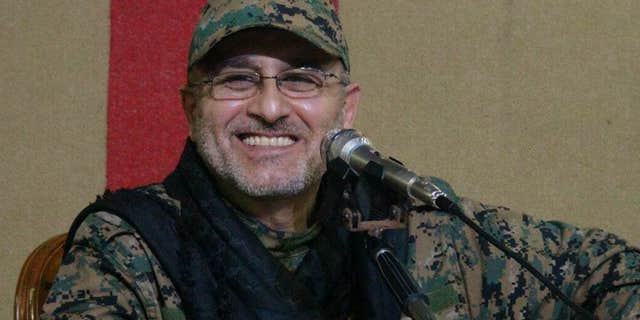 This undated handout image released on Friday, May 13, 2016, by Hezbollah Media Department, shows slain top military commander Mustafa Badreddine smiling during a meeting.