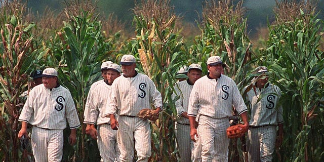 In this June 22, 1997, file photo, Ghost Players emerge from the cornfield at the "Field of Dreams" movie site in Dyersville, Iowa.