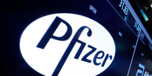 File-This April 6, 2016, file photo shows the Pfizer logo appearing on a screen above its trading post on the floor of the New York Stock Exchange.