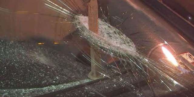 Photo shows spike going through windshield.