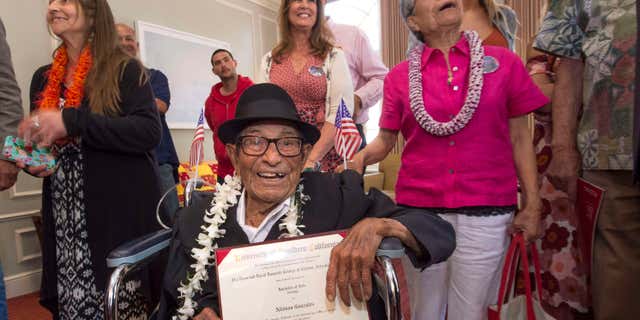 May 13, 2016: Alfonso Gonzales, 96, University of Southern California's oldest graduating Trojan receives his Bachelor of Science degree in zoology diploma from USC surrounded by family members, as part of the 2016 USC Commencement ceremony.