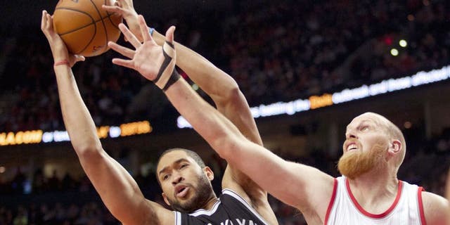 Nov 15, 2014; Portland, OR, USA; Brooklyn Nets center Jerome Jordan (9) and Portland Trail Blazers center Chris Kaman (35) go up for a rebound at Moda Center at the Rose Quarter. Mandatory Credit: Jaime Valdez-USA TODAY Sports