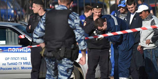 May 14, 2016: Police investigators work on the site of a brawl at the Khovanskoye cemetery in in Moscow, Russia.
