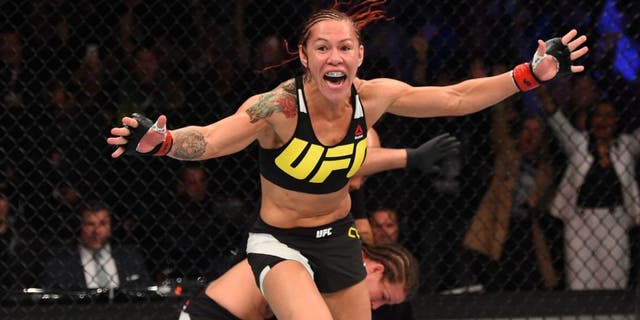 CURITIBA, BRAZIL - MAY 14: (L-R) Cristiane 'Cyborg' Justino of Brazil celebrates after defeating Leslie Smith in their women's catchweight bout during the UFC 198 event at Arena da Baixada stadium on May 14, 2016 in Curitiba, Parana, Brazil. (Photo by Josh Hedges/Zuffa LLC/Zuffa LLC via Getty Images)