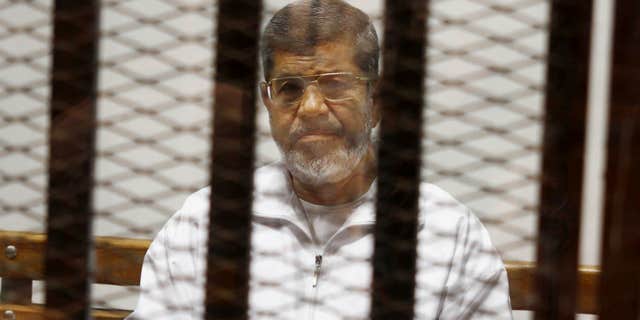 May 8, 2014: Egypt's ousted Islamist President Mohammed Morsi sits in a defendant cage in the Police Academy courthouse in Cairo, Egypt.