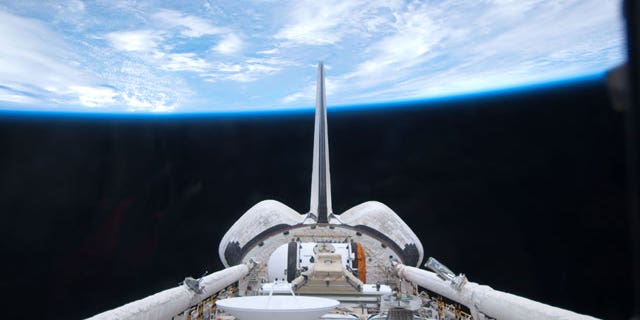 May 15: In this image provided by NASA, space shuttle Atlantis' cargo bay and its vertical stabilizer intersecting Earth's horizon was provided on by one of the six STS-132 crew members.