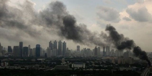 May 16: Heavy smoke appears as anti-government protesters burn tires at a main road in downtown Bangkok, Thailand.