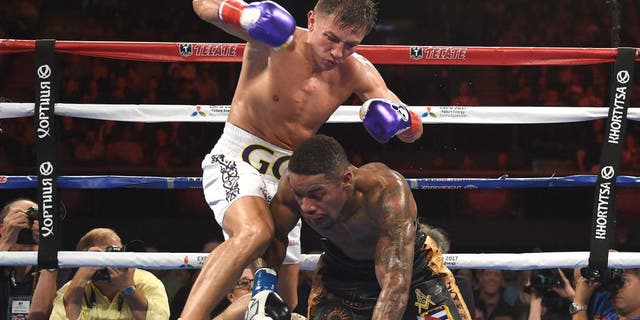 Boxer Gennady Golovkin from Kazakhstan knocks out Willie Monroe of the US in the sixth round during their Middleweight World Championship bout at the Forum Arena in Los Angeles, California on May 16, 2015. AFP PHOTO / MARK RALSTON (Photo credit should read MARK RALSTON/AFP/Getty Images)