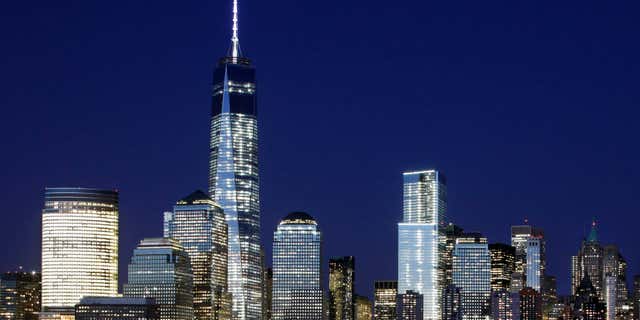 May 6, 2015: A mostly illuminated One World Trade Center towers over the lower Manhattan skyline in New York.