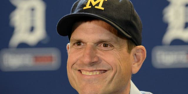 DETROIT, MI - JUNE 30: University of Michigan head football coach Jim Harbaugh looks on and smiles while talking to the media prior to the Major League Baseball game between the Pittsburgh Pirates and the Detroit Tigers at Comerica Park on June 30, 2015 in Detroit, Michigan. (Photo by Mark Cunningham/MLB Photos via Getty Images)