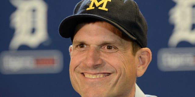 DETROIT, MI - JUNE 30: University of Michigan head football coach Jim Harbaugh looks on and smiles while talking to the media prior to the Major League Baseball game between the Pittsburgh Pirates and the Detroit Tigers at Comerica Park on June 30, 2015 in Detroit, Michigan. (Photo by Mark Cunningham/MLB Photos via Getty Images)