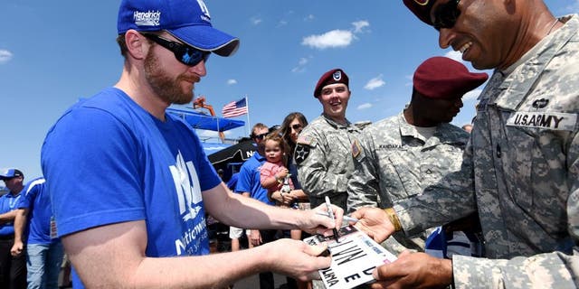CHARLOTTE, NC - MAY 24: Dale Earnhardt Jr., driver of the #88 Nationwide Chevrolet, signs autographs for U.S. Army members prior to the NASCAR Sprint Cup Series Coca-Cola 600 at Charlotte Motor Speedway on May 24, 2015 in Charlotte, North Carolina. (Photo by Rainier Ehrhardt/Getty Images)