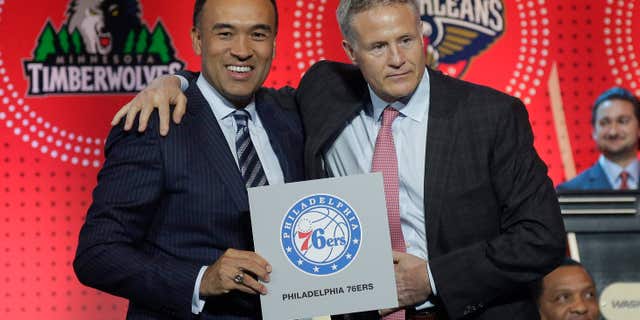 NBA deputy commissioner Mark Tatum, left, poses for a photo with Philadelphia 76ers head coach Brett Brown during the NBA basketball draft lottery, Tuesday, May 17, 2016, in New York.