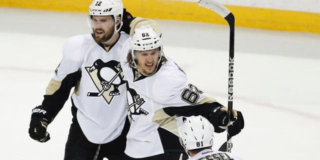 May 18, 2016; Tampa, FL, USA; Pittsburgh Penguins left wing Carl Hagelin (62) celebrates a goal with teammates right wing Phil Kessel (81) and defenseman Ben Lovejoy (12) during the second period in game three of the Eastern Conference Final against the Tampa Bay Lightning of the 2016 Stanley Cup Playoffs at Amalie Arena. Mandatory Credit: Reinhold Matay-USA TODAY Sports