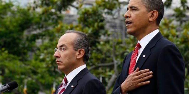 President Obama stands with Mexican President Felipe Calderon during the playing of the American National Anthem, on the South Lawn of the White House in Washington, Wednesday, May 19, 2010. President Calderon will be attending a state dinner at the White House with President Obama later in the evening (AP).