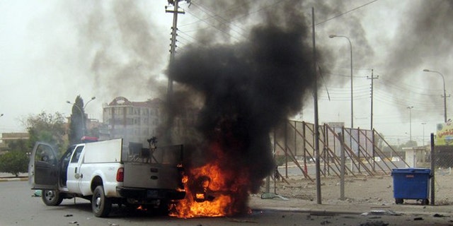 May 19: A car burns following a bomb attack in the northern oil-rich city of Kirkuk, killing at least 27 people.