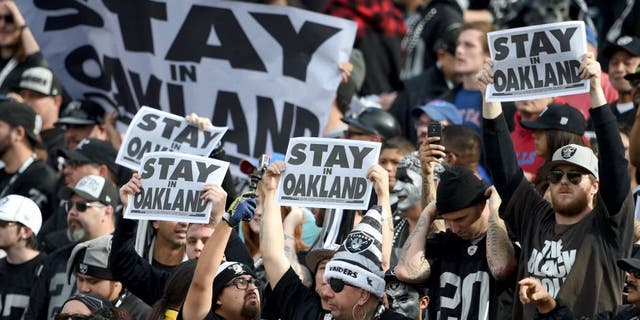 December 21, 2014; Oakland, CA, USA; Oakland Raiders fans hold up signs before the game against the Buffalo Bills at O.co Coliseum. Mandatory Credit: Kyle Terada-USA TODAY Sports