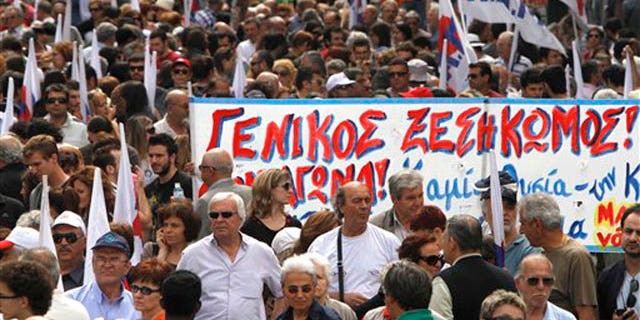 May 20: Demonstrators hold a banner which reads in Greek "General uprising'' during a march organized by a Communist-backed labor union, in central Athens.