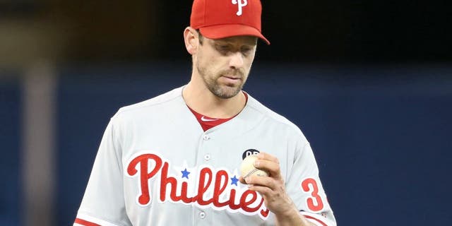 TORONTO, CANADA - MAY 7: Cliff Lee #33 of the Philadelphia Phillies inspects a baseball during MLB game action against the Toronto Blue Jays on May 7, 2014 at Rogers Centre in Toronto, Ontario, Canada. (Photo by Tom Szczerbowski/Getty Images)