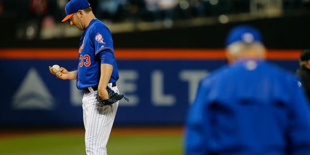 NEW YORK, NY - MAY 19: Pitcher Matt Harvey #33 of the New York Mets stares at the ball as manager Terry Collins #10 comes out to relieve him during the third inning of a game at Citi Field on May 19, 2016 in the Flushing neighborhood of the Queens borough of New York City. (Photo by Rich Schultz/Getty Images)