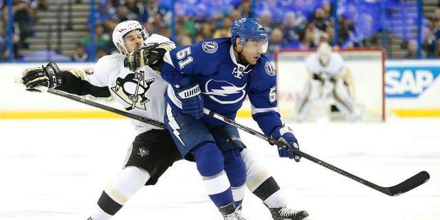 May 20, 2016; Tampa, FL, USA; Pittsburgh Penguins center Sidney Crosby (87) and Tampa Bay Lightning center Valtteri Filppula (51) fight to control the puck during the second period of game four of the Eastern Conference Final of the 2016 Stanley Cup Playoffs at Amalie Arena. Mandatory Credit: Kim Klement-USA TODAY Sports