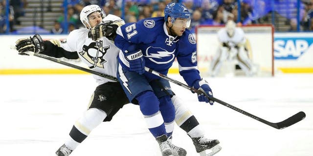 May 20, 2016; Tampa, FL, USA; Pittsburgh Penguins center Sidney Crosby (87) and Tampa Bay Lightning center Valtteri Filppula (51) fight to control the puck during the second period of game four of the Eastern Conference Final of the 2016 Stanley Cup Playoffs at Amalie Arena. Mandatory Credit: Kim Klement-USA TODAY Sports