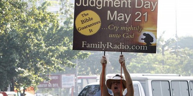 May 13: Debra Schaper of Maryland, who is a member of a religious group called Family Radio, displays a placard while spreading the group's prediction that the world will end on May 21, 2011.