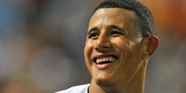 May 19, 2015; Baltimore, MD, USA; Baltimore Orioles third baseman Manny Machado (13) stands at the top of the dugout during the seventh inning against the Seattle Mariners at Oriole Park at Camden Yards. Baltimore Orioles defeat Seattle Mariners 9-4. Mandatory Credit: Tommy Gilligan-USA TODAY Sports