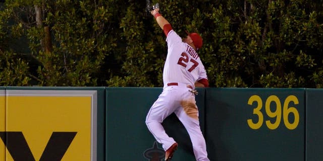ANAHEIM, CA - SEPTEMBER 26: Mike Trout #27 of the Los Angeles Angels of Anaheim makes a catch high over the wall to rob Jesus Montero of the Seattle Mariners of what would have been a three-run home run during the fourth inning of the game against the Seattle Mariners at Angel Stadium of Anaheim on September 26, 2015 in Anaheim, California. (Photo by Matt Brown/Angels Baseball LP/Getty Images)