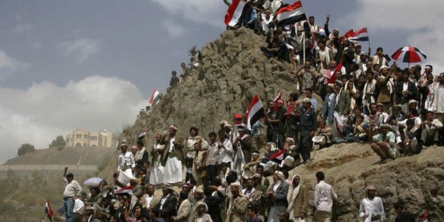 May 22: Anti-government protesters gather on a hillside to watch a ceremony commemorating the anniversary of Yemen's reunification in Sanaa (Reuters).