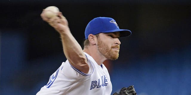 Toronto Blue Jays starting pitcher Liam Hendriks throws against the Oakland Athletics during the first inning of a baseball game Friday, May 23, 2014, in Toronto. (AP Photo/The Canadian Press, Frank Gunn)