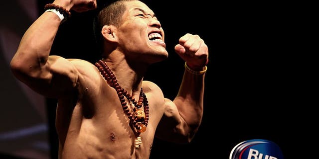 LAS VEGAS, NV - MAY 23: Li Jingliang of China steps on the scale during the UFC 173 weigh-in event at the MGM Grand Garden Arena on May 23, 2014 in Las Vegas, Nevada. (Photo by Brandon Magnus/Zuffa LLC/Zuffa LLC via Getty Images)