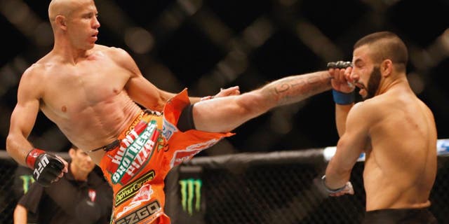 (L-R) Donald Cerrone kicks John Makdessi of Canada in their lightweight bout during the UFC 187 event at the MGM Grand Garden Arena on May 23, 2015 in Las Vegas, Nevada. (Photo by Christian Petersen/Zuffa LLC/Zuffa LLC via Getty Images)
