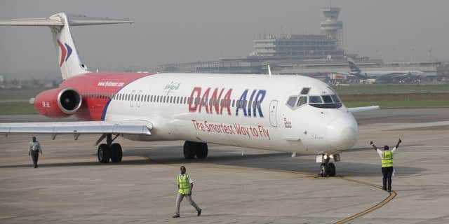 Jan. 4, 2013: Dana airline ground staff signal to the pilot during a demonstration Lagos- Abuja flight with celebrities, journalists and the airline executives at the Murtala Muhammed airport in Lagos, Nigeria.