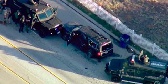 FILE - In this Dec. 2, 2015, file image, taken from video, armored vehicles surround an SUV following a shootout in San Bernardino, Calif.