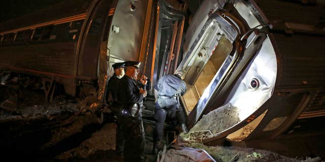 May 12, 2015: Emergency personnel work the scene of a train wreck An Amtrak train headed to New York City derailed and crashed in Philadelphia.