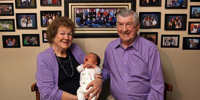 April 17, 2015: Leo and Ruth Zanger sit with their 100th grandchild, Jaxton Zanger, in Leo's real estate office in Quincy, Ill.