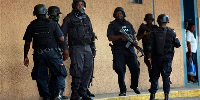 May 26: Police officers stand guard near the emergency room entrance of the national hospital in Kingston, Jamaica.