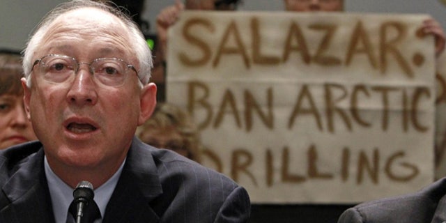 May 26: Greenpeace protesters hold up a banner as Secretary of the Interior Ken Salazar testifies before the House.