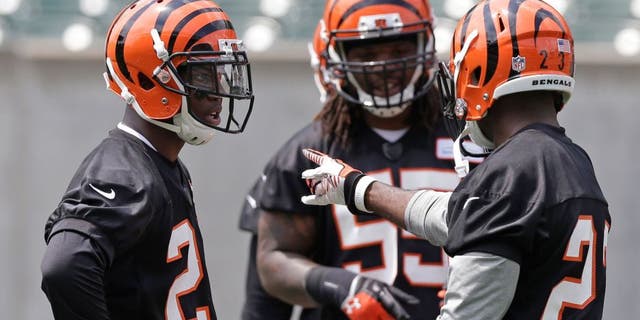 Cincinnati Bengals first round draft pick Darqueze Dennard, a cornerback from Michigan State, left, gets instructions from veteran cornerback Terence Newman, right, during an NFL football organized team activity, Tuesday, May 27, 2014, in Cincinnati. (AP Photo/Al Behrman)