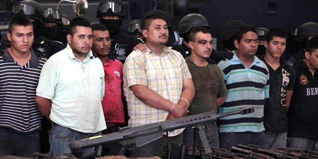 May 28: Federal police present to the news media a cache of weapons and nearly 50 suspects of two major drug cartels in Mexico City.